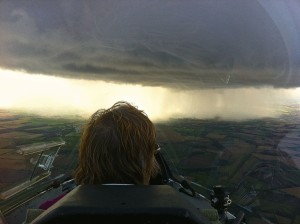 The back of Pauline Larners head watching an approaching shower cloud before a dash for the airfield